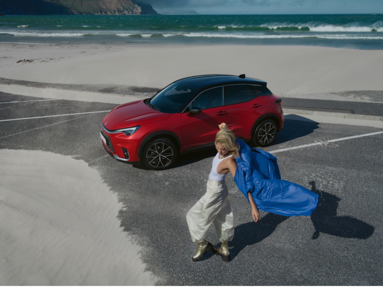 A person dancing nex to a Lexus LBX