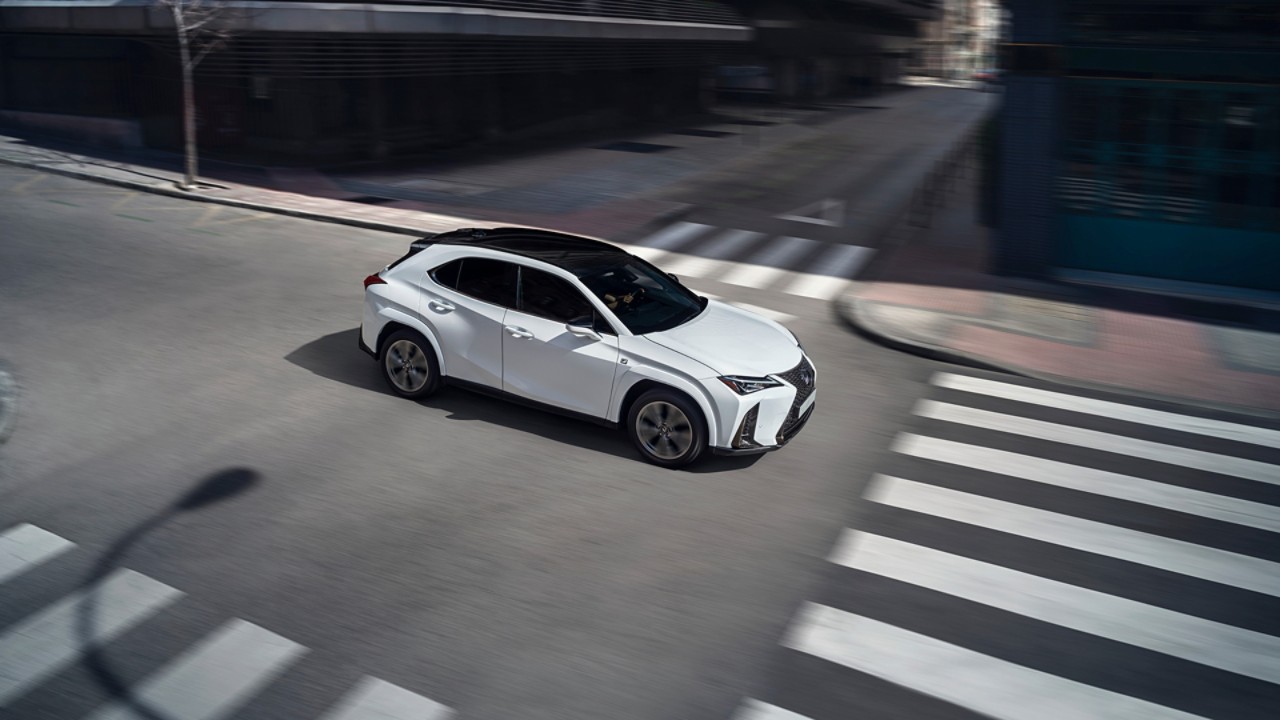 A Lexus UX driving through a junction 