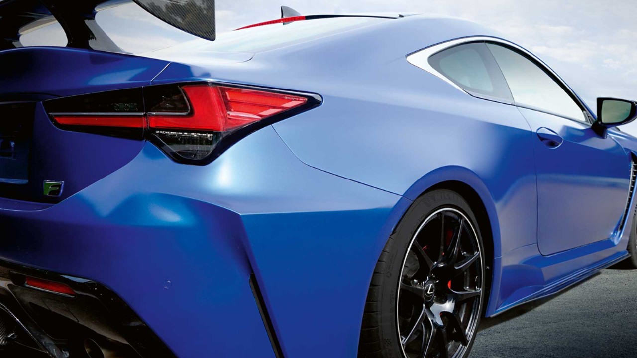 A front close-up of the RC F driving through a city street