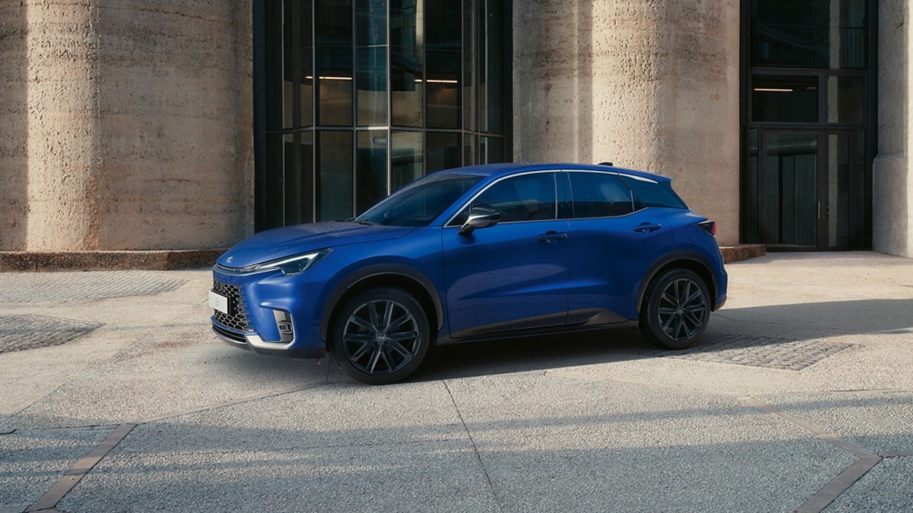 A Lexus UX 300e plugged into a charging tower