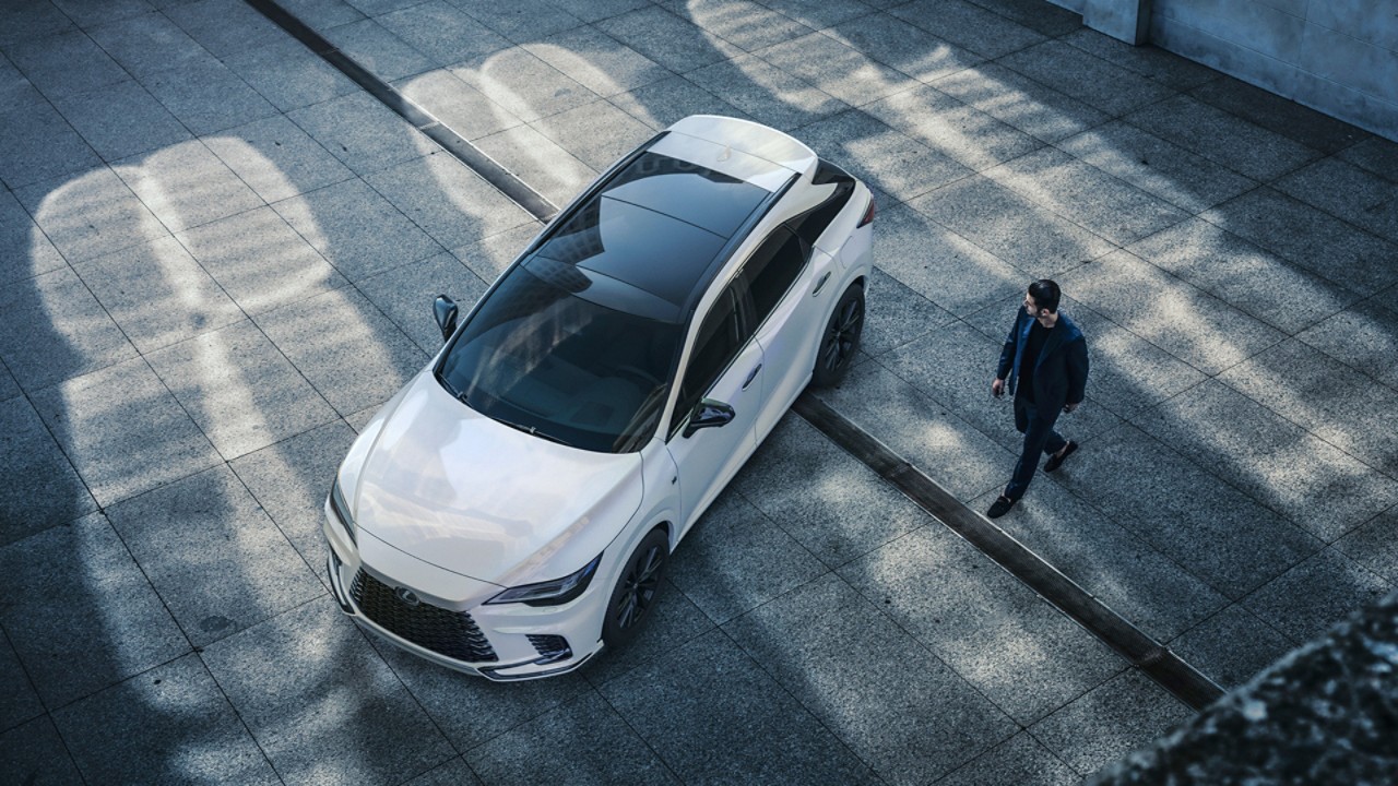 A person stood next to a Lexus RX